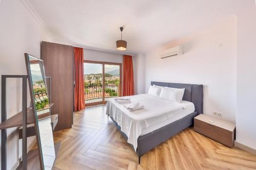 a bedroom with a bed and a large window at The Townhouse Apartment in Kaş