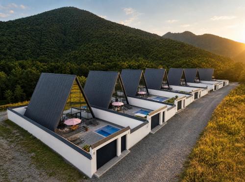 a row of luxury resorts in front of a mountain at Qafqaz Falcon Chalet in Gabala