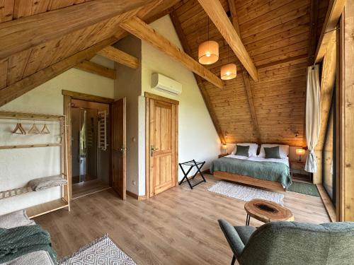 a bedroom with a bed in a wooden house at Chata Rosocha domek na wyłączność in Cisna