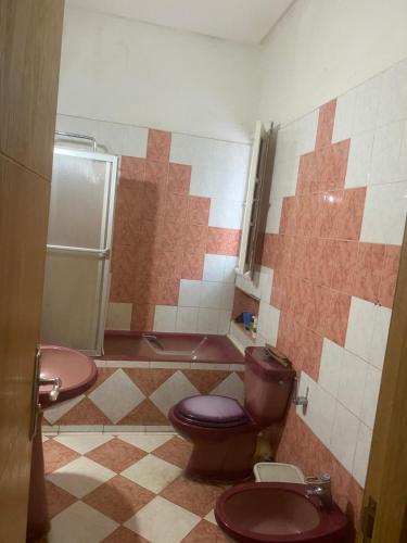 a bathroom with a toilet and a sink and a tub at Belle Villa in Casablanca