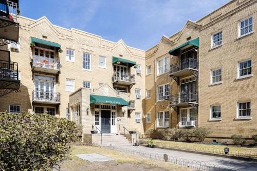 a row of brick apartment buildings with balconies at Chic Studio Apartment on Oglethorpe Square in Savannah