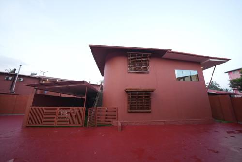 a red house with windows on the side of it at Saj Earth Resort , Cochin Airport in Nedumbassery