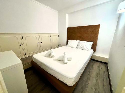 a bedroom with a bed with two candles on it at Casa do Mar & Sesimbra Center View in Sesimbra
