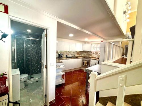 a small kitchen with a sink and a toilet at Casa do Mar & Sesimbra Center View in Sesimbra