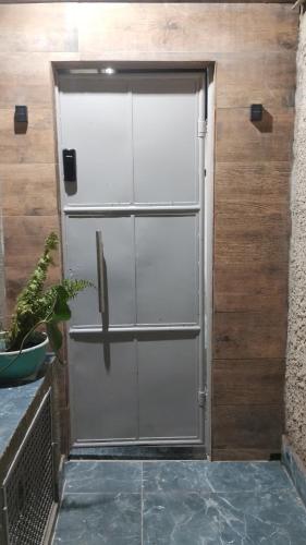 a metal door on a wooden wall at Loft Moderno 1 in Volta Redonda