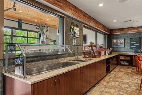 a kitchen with a sink and a large window at The Inn On The River in Pigeon Forge