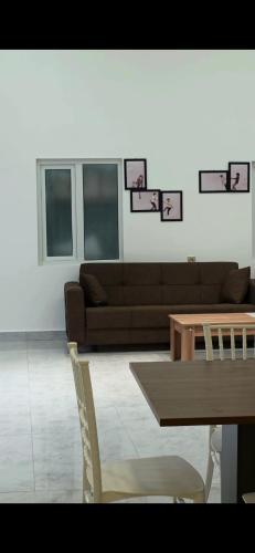 a living room with a couch and a table at Econom Hostel Ganja in Ganja