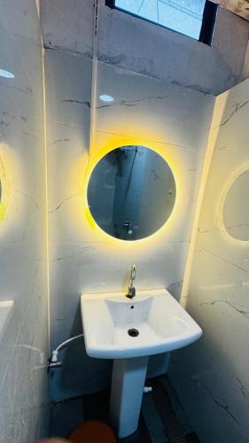 a bathroom with a white sink and a mirror at Hotel shree lodging in Jogeshwāri