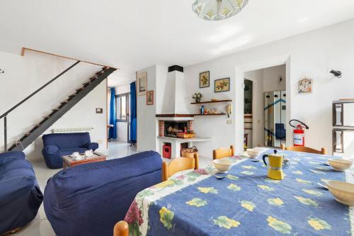 a living room with a table and blue chairs at Casa Violina - Portoferraio in Portoferraio