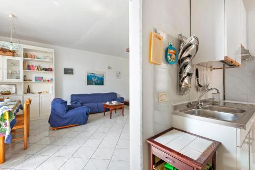 a kitchen and a living room with a sink at Casa Violina - Portoferraio in Portoferraio
