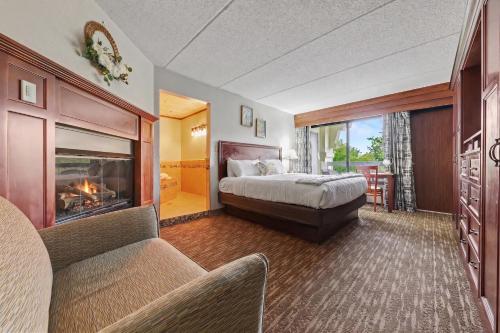 a bedroom with a bed and a fireplace at The Inn On The River in Pigeon Forge