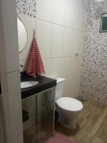 a bathroom with a toilet and a sink and a mirror at Residencial Beatriz centro in Formosa