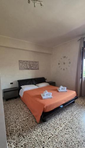 a bedroom with a bed and a clock on the wall at Scicocco Sweet Home in Bagnoli del Trigno