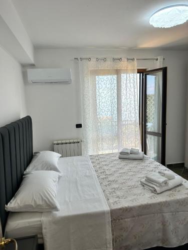 a bedroom with a bed with two towels on it at Casa Vacanze Scilla in Scilla