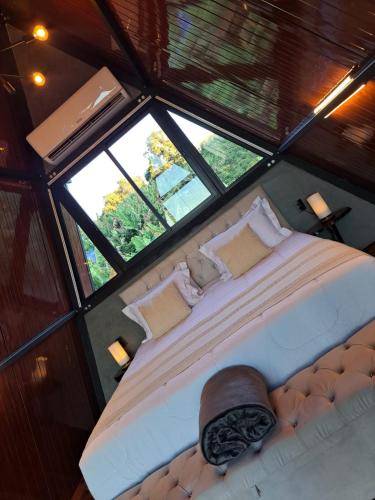 a large bed in a room with windows at Paradise In Coffee in Socorro
