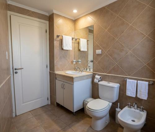a bathroom with a toilet and a sink at Torre Melos, 2do piso, centro, con cochera in Villa Carlos Paz