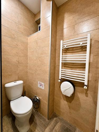 a bathroom with a white toilet in a room at Boutique Hotel Iveria in Tbilisi City