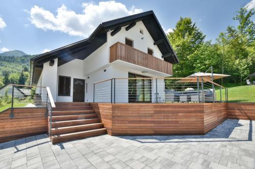a house with a large deck and stairs at Villa Belica in Bohinj