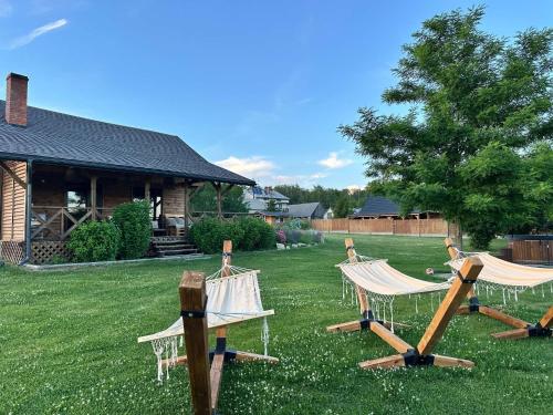 a group of lawn chairs sitting in a yard at Brzozowa Polanka II in Lipowiec Stary