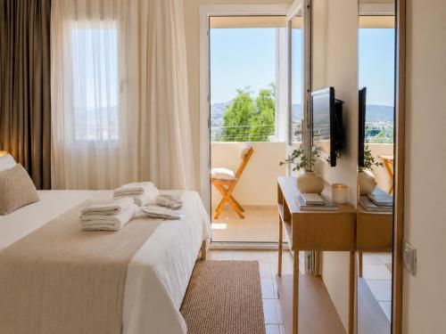 a bedroom with a bed and a television and a balcony at Ciello Hotel Bodrum Adults Only 14 in Bodrum City