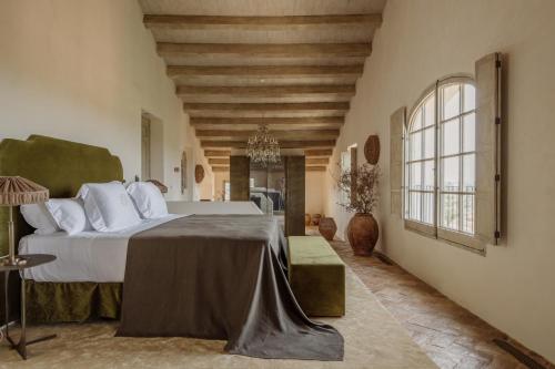 a bedroom with a large bed in a room at Vestige Son Vell in Ciutadella