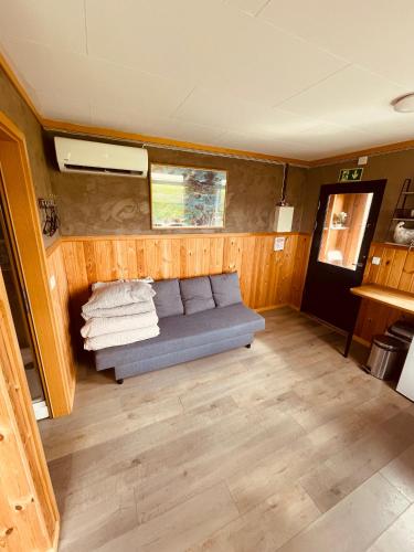 a living room with a couch in a room at Vestra-Fíflholt cabin 3 in Hvolsvöllur