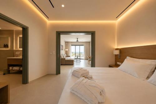 a bedroom with a bed with two towels on it at LEOLIA Nautical Resort Kala Nera - Handwritten Collection in Volos