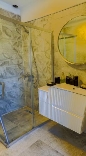 a bathroom with a shower and a sink and a mirror at Ciello Hotel Bodrum Adults Only 14 in Bodrum City