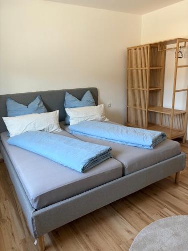a couch with two pillows on it in a room at Modern Apartment 1 Graf - New! in Grafenwöhr