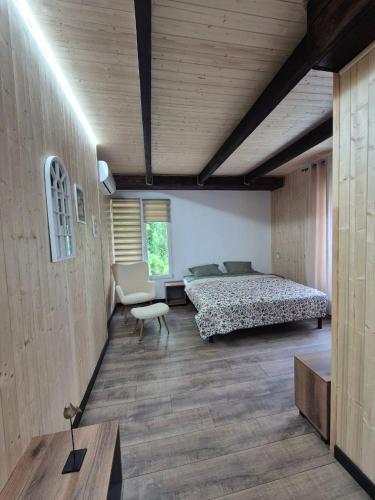 a large bedroom with a bed and a chair at Sunpark in Vadul lui Vodă