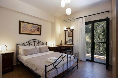 a bedroom with a bed and a large window at Argyro Villa in Bali