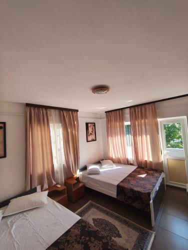 a bedroom with a large bed and a window at vila CALIL in Eforie Nord