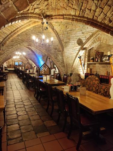 a dining room with wooden tables and chairs at Hotel Am Hopfenmarkt in Rostock