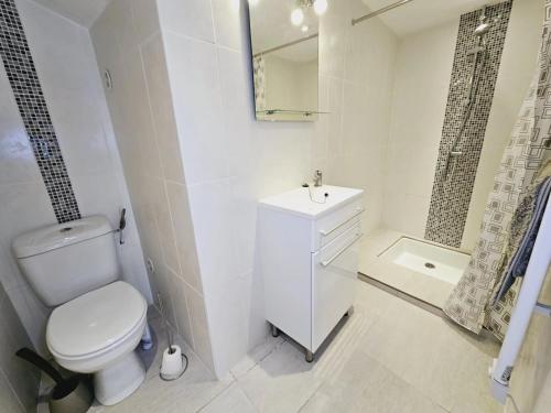 a bathroom with a toilet and a sink and a shower at Le Bel Coin in Ginoles