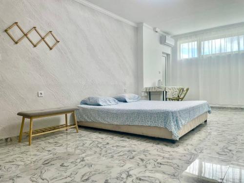 a bedroom with a bed and a table in it at Sol e Mar in Sunny Beach