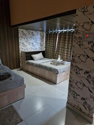 a bedroom with a bed in a room at Theglassystay in Raipur