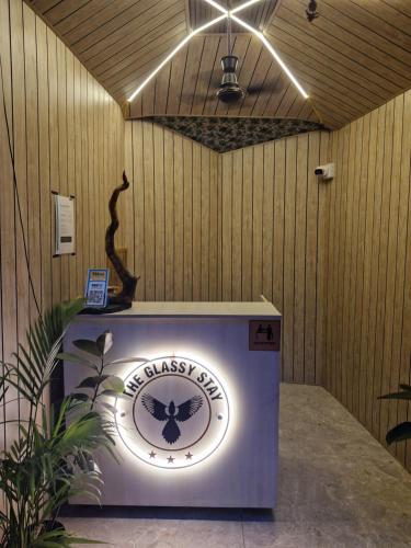 a wall with a sign that says the glassiest shop at Theglassystay in Raipur