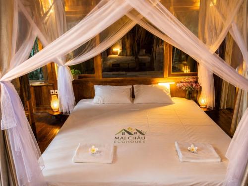 a bedroom with a bed in a tent at Mai Chau Ecohouse in Mai Châu