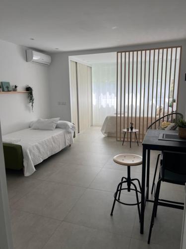 a bedroom with a bed and a desk in it at Apartaestudio Playa Paraíso in Aguadulce
