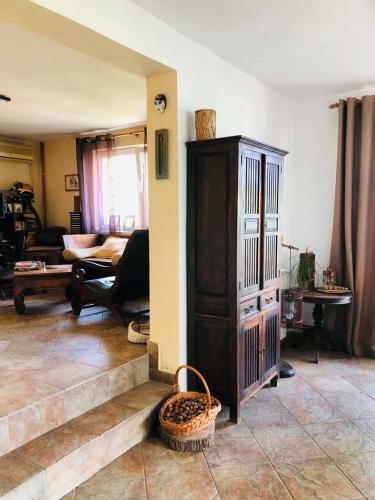 a living room with a large wooden cabinet and stairs at A house with the view in Bar