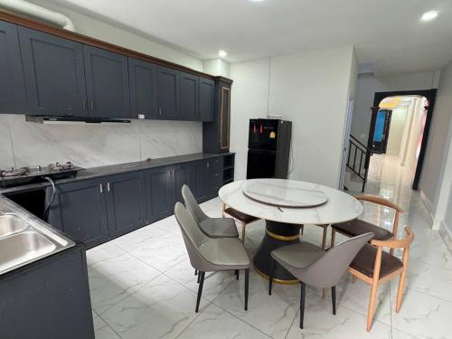 a kitchen with a table and chairs and a refrigerator at Ashmita Shahi House in Kathmandu