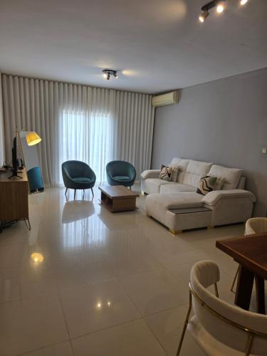 a living room with a couch and two chairs at C7 double up in Camama