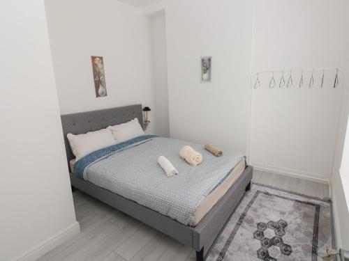 a bedroom with a bed with two pillows on it at 5 Gelli Terrace in Caerphilly