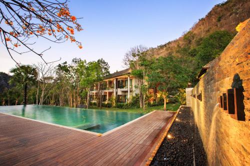 a house with a swimming pool next to a building at The Series Resort Khaoyai in Phayayen
