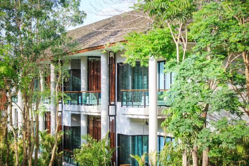 a building with trees in front of it at The Series Resort Khaoyai in Phayayen