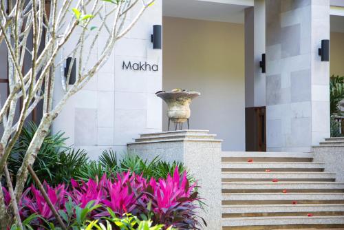 a building with a staircase and pink flowers at The Series Resort Khaoyai in Phayayen
