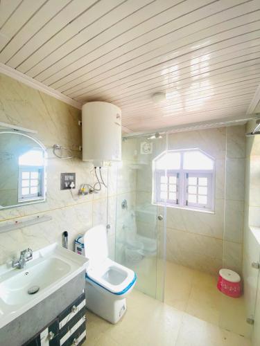 a bathroom with a toilet and a sink at Rahat Resort in Srinagar