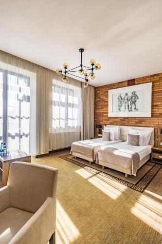 a large bedroom with two beds and a couch at Hotel Zamek Gniew in Gniew