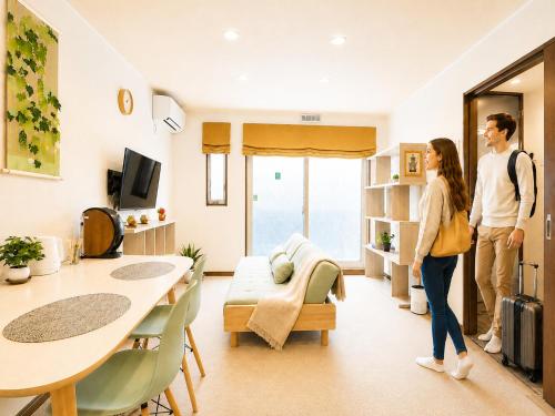 a man and a woman standing in a living room at Vieuno Hida Takayama 5-Min Walk to Station, Cozy Local Stay in Takayama