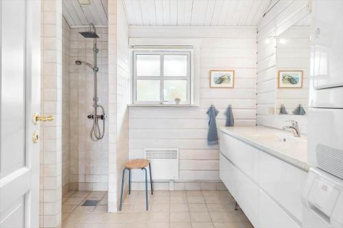 a bathroom with a shower and a sink and a stool at LN1926-Hjorring-Jollevej-2 in Hjørring